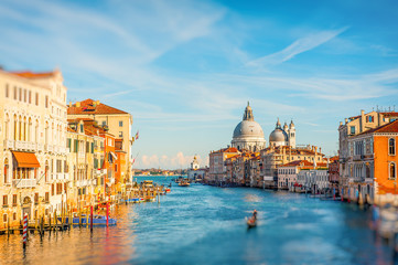Bright sunny view of The Grand Canal with gondola the Santa Maria della Salute church, Venice, Italy