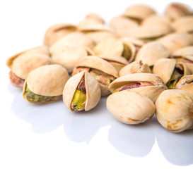 Pistachio nuts over white background