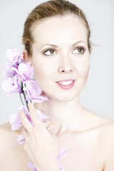 Fototapeta premium Woman holding up Orchids