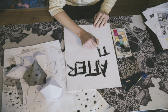 Illustrator sketching sign at her creative desk