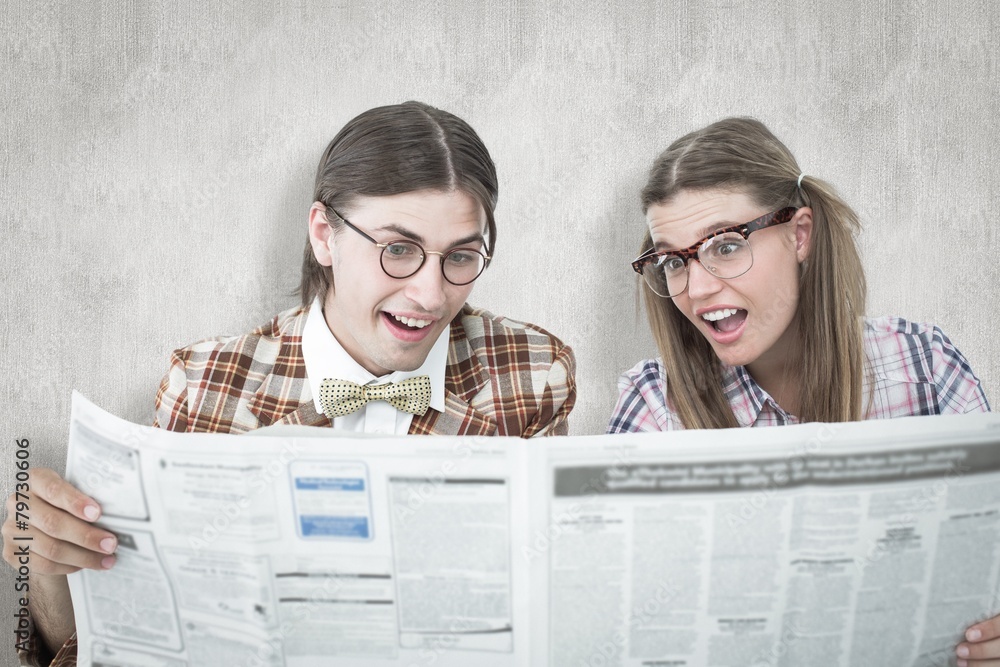 Poster Composite image of geeky hipsters reading the newspaper