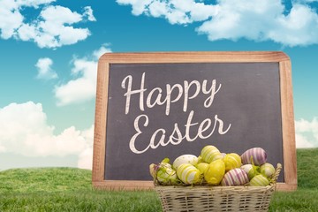 Composite image of easter eggs in basket