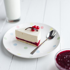 White cheesecake with red berries on a wooden table. Still life