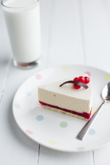 White cheesecake with red berries on a wooden table. Still life