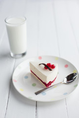 White cheesecake with red berries on a wooden table. Still life