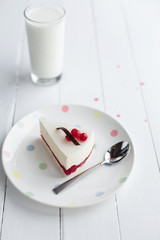 White cheesecake with red berries on a wooden table. Still life