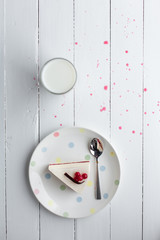 White cheesecake with red berries on a wooden table. Still life