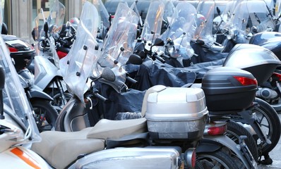 scooters and mopeds with winter windshield parked