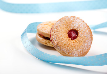 Cookies with jam with blue strip on white background