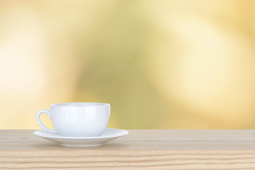 white cup of coffee on pine Wooden Table and bokeh,defocused lig