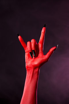 Devil hand showing heavy metal gesture