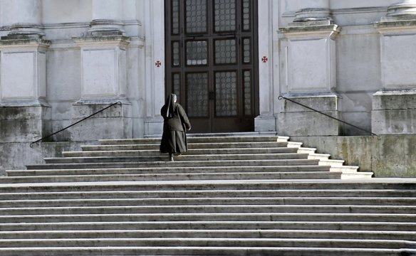 nun who climbs the stairs of the Church