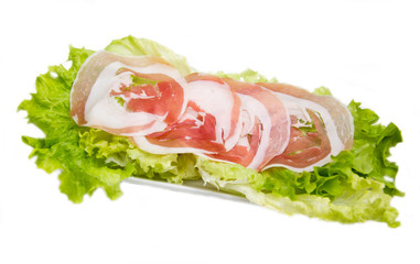 Rolled bacon on salad on white background