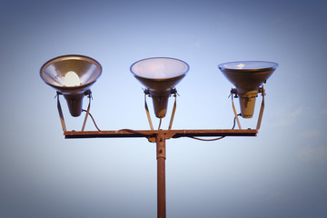 Three projectors of light against the sky background