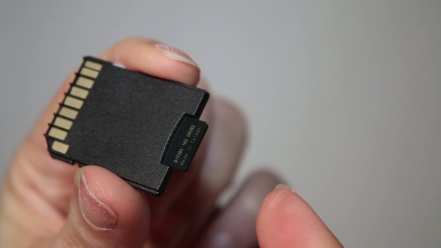 Sliding MicroSD Card Into MiniSD Adapter Close Up