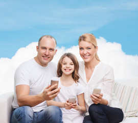happy family with smartphones