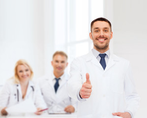 smiling male doctor showing thumbs up