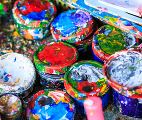 Fototapeta na wymiar Colorful paintbrushes and paint tanks
