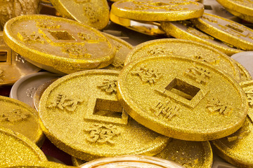 Chinese coins of gold color shot close-up cues