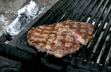 steaks cooked on a grill in the restaurant