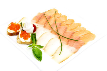 sandwiches with caviar and sliced fish on a white plate