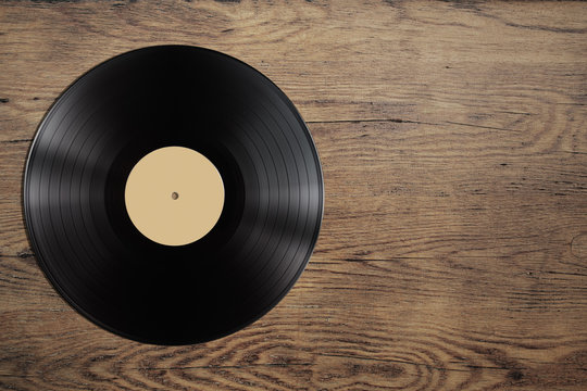 vynil record disc on wooden table