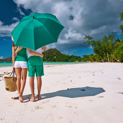 Couple in green on a beach at Seychelles