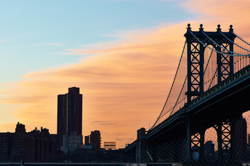 Manhattan Bridge and skyline silhouette at sunset