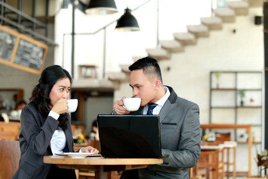 businessman and businesswoman taking a coffee break