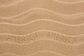 Fototapeta na wymiar America inscription on the wavy sand