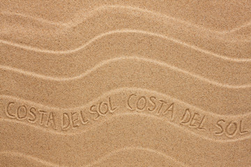 Costa del Sol inscription on the wavy sand