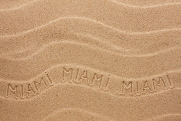 Miami inscription on the wavy sand