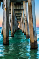 Zelfklevend Fotobehang Underside of pier in Panama City Beach, Florida, at sunrise © Robert Hainer