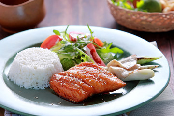 salmon teriyaki served with rice and salad