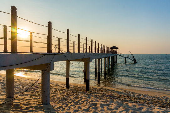 Beautiful sunset at tropical beach with jetty