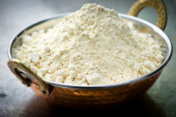 Flour from chick-pea in the Indian copper bowl