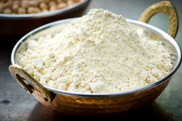 Flour from chick-pea in the Indian copper bowl