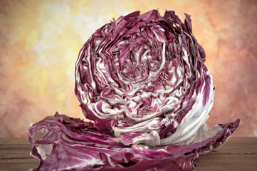 Obraz premium Round chicory radicchio on wooden table