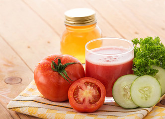 a glass of fresh tomato mix cucumber juice with ingredients