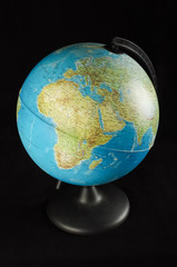 Travel concept. Plastic earth globe model isolated