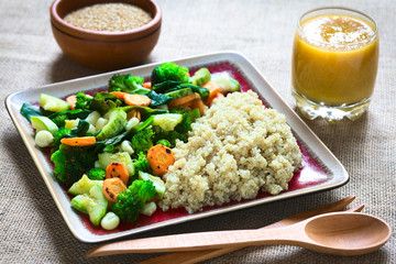 Cooked white quinoa seeds with fried vegetables