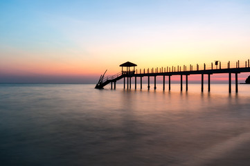 Fototapeta na wymiar Colorful sunset at tropical beach with jetty