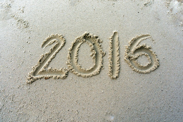 Fototapeta premium Year 2016 written on the sand at beach