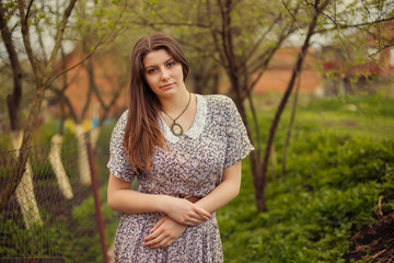Portrait of young woman in old vintage dress in garden, park in