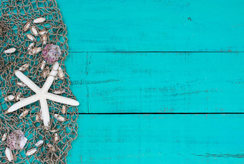 Blank sign with seashells and starfish in fish net border