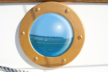 Seascape reflection in sailboat porthole