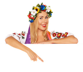 Attractive woman wears Ukrainian national dress behind board