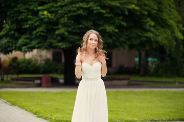 Alluring brown-haired woman outdoors in luxury elegant dress