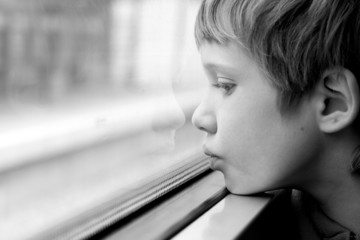 Cute Boy looking through the window