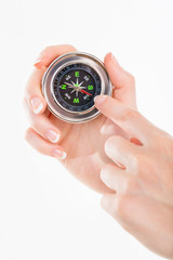 Woman holding small compass. Isolated in a white background.
